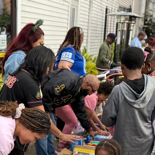 Community volunteers handing out gifts and supplies to families